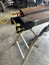 Fabricated hitch assembly clamped on a work stand