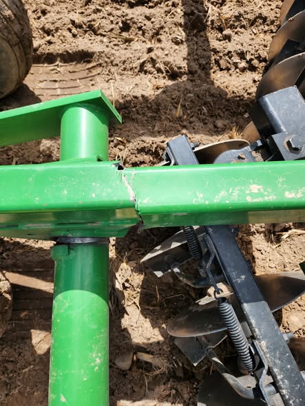 Field repair on a green farm implement frame