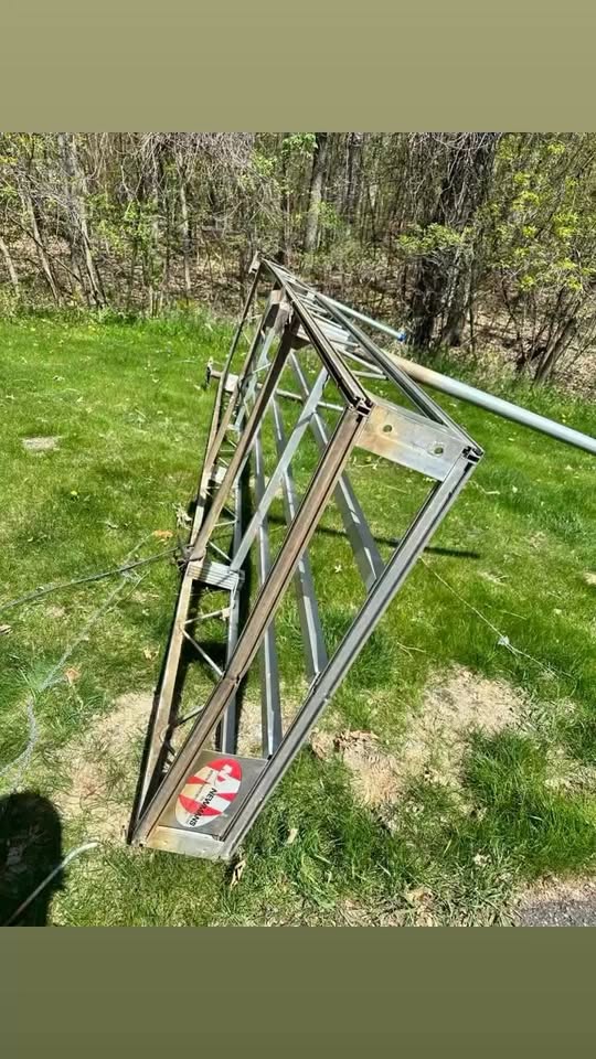 Large fabricated steel truss frame laid out on grass